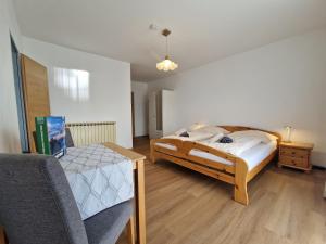 a bedroom with a bed and a table and a chair at Ferienwohnung Andritsch in Sankt Georgen im Gailtal