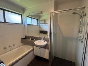 a bathroom with a sink and a tub and a shower at Barwon Valley Lodge in Geelong +28 photos