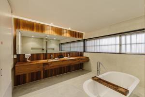 a bathroom with a tub and a large mirror at TTR Rin Villa & Hotel in Da Lat +35 photos