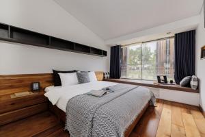 a bedroom with a large bed and a window at TTR Rin Villa & Hotel in Da Lat