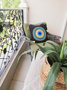 a bench with a pillow on a balcony with a plant at Luxury Studio with Balcony in Sunny Beach +18 photos