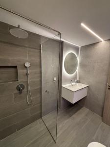 a bathroom with a shower and a sink at Fabio apartment in Amarynthos