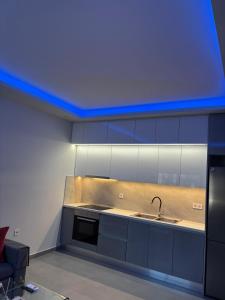 a kitchen with a sink and a blue ceiling at Fabio apartment in Amarynthos +7 photos