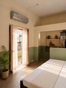 a bedroom with a bed and a window at Shristays in Varanasi