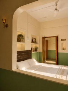 a bedroom with a large bed with a mirror at Shristays in Varanasi