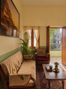 a living room with a couch and a table at Shristays in Varanasi