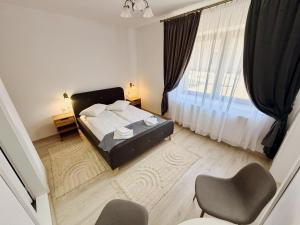 a bedroom with a bed and a large window at Casa ZUGO in Borsec +23 photos