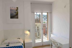 a bedroom with a bed and a desk and a window at Pedro in Roses