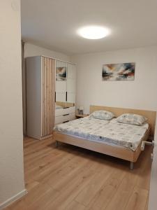 a bedroom with a bed and a wooden floor at Apartmani Gero in Lopar +98 photos