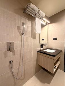 a bathroom with a shower with a sink and a mirror at hotel midas in Sāgar +18 photos