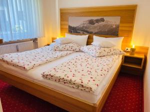 a bedroom with two beds with flowers on them at Ferienwohnungen Boxler in Oberstdorf