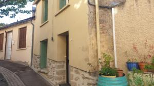an alley with pots of plants next to a building at Maison clara 2 rue du centre in Clara