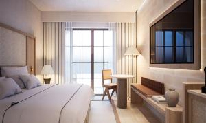 a bedroom with a bed and a table and a window at Casa Azure Meliá Collection in San Lawrenz