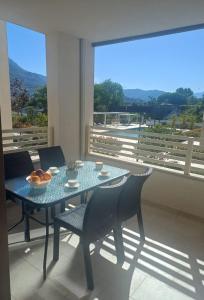 a table and chairs in a room with a large window at Lira Bay in Igalo