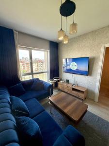a living room with a blue couch and a table at Classic Suite MK1 in Istanbul