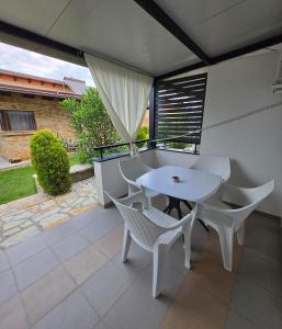 a white table and chairs on a balcony at Apartments and Villas Janev in Star Dojran