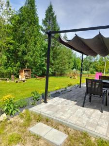 a patio with a table and an umbrella at Przystanek Bereżnica in Bereżnica Wyżna +4 photos