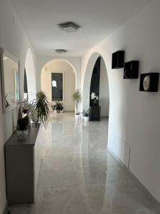 a large hallway with white walls and a tile floor at Apartman Ariana in Ližnjan