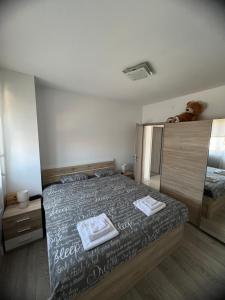 a bedroom with a bed with two towels on it at Apartman Ariana in Ližnjan