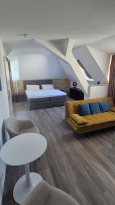 a living room with a couch and a table at Hotel PrimaVera parco in Fürth +76 photos