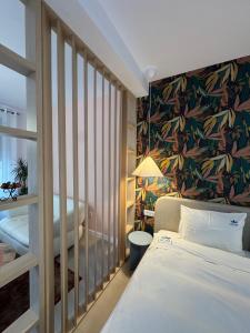 a hotel room with a bed and a wall mural at Lucas 10 Apartments in Cluj-Napoca