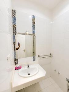 a white bathroom with a sink and a mirror at Karnak Hotel Luxor in Luxor