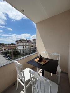 a balcony with a table and chairs and a view at Hotel Palace Struga in Struga