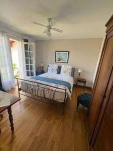 a bedroom with a large bed and a window at Villa Les Hortensias B&B in Arcangues