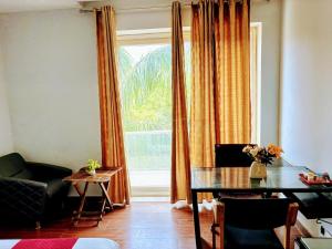 a living room with a table and a window at VRResidency in Gurgaon