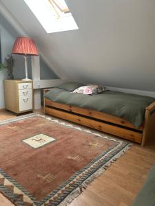 a bedroom with a bed and a lamp and a rug at Villa grain de sel in Étaples