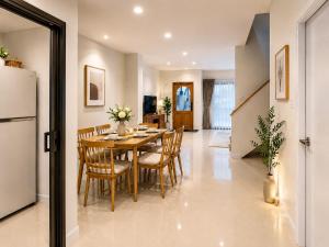 a kitchen and dining room with a table and chairs at Urban Homie 40 in Langu