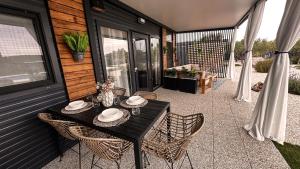 a patio with a table and chairs on a house at Ausblick Sunce i More Mobilehome in Pirovac