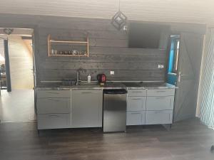 a kitchen with white cabinets and a sink at Noclegi Zakątek in Okuninka