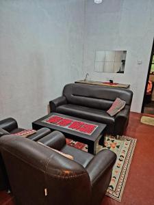 a living room with two chairs and a couch at Sampath State in Koslanda