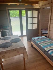a room with a bed and a table at Noclegi Zakątek in Okuninka +1 photo