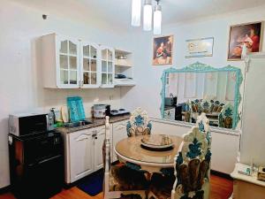 a kitchen with a table and chairs in a room at Condotels at Albergo Hotel Baguio in Baguio
