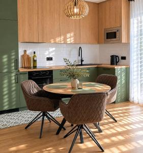 a kitchen with a table and chairs in a kitchen at Villa AdriaBelle in Tivat