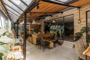 a patio with a table and chairs in a building at TTR Rin Villa & Hotel in Da Lat