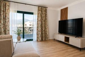 a living room with a large flat screen tv at Villa AdriaBelle in Tivat