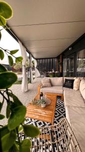 a living room with a couch and a table at Ausblick Sunce i More Mobilehome in Pirovac