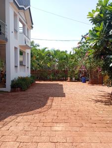 a brick driveway in front of a building at Satvik Homestay in Devgarh