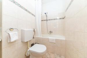 a bathroom with a toilet and a bath tub at Apartmani Villa Biočić in Split +20 photos