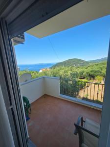 a balcony with a view of the ocean at Olive Tree Apartments in Parga