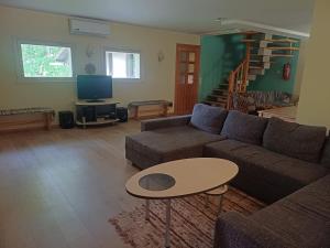 a living room with a couch and a table at Laugu Guesthouse in Kuusalu