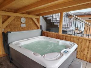 a large bath tub in a room with a staircase at MOUNTAIN DELUXE 27 APARTMENTS con WELLNESS in Cavalese