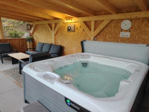 a large hot tub in a room with a table and chairs at MOUNTAIN DELUXE 27 APARTMENTS con WELLNESS in Cavalese