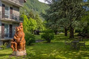 a statue of a bear with a baby sitting on it at Residence CATULLO in Bezzecca +8 photos