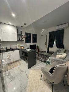 a kitchen and living room with a couch and a table at Mimis House in Tsotílion