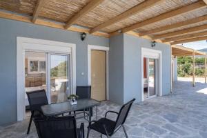 a patio with a table and chairs and a dining room at Studios Maximo in Karavádhos