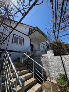 a building with stairs in front of a house at Shiroke Relax Villa in Shirokë